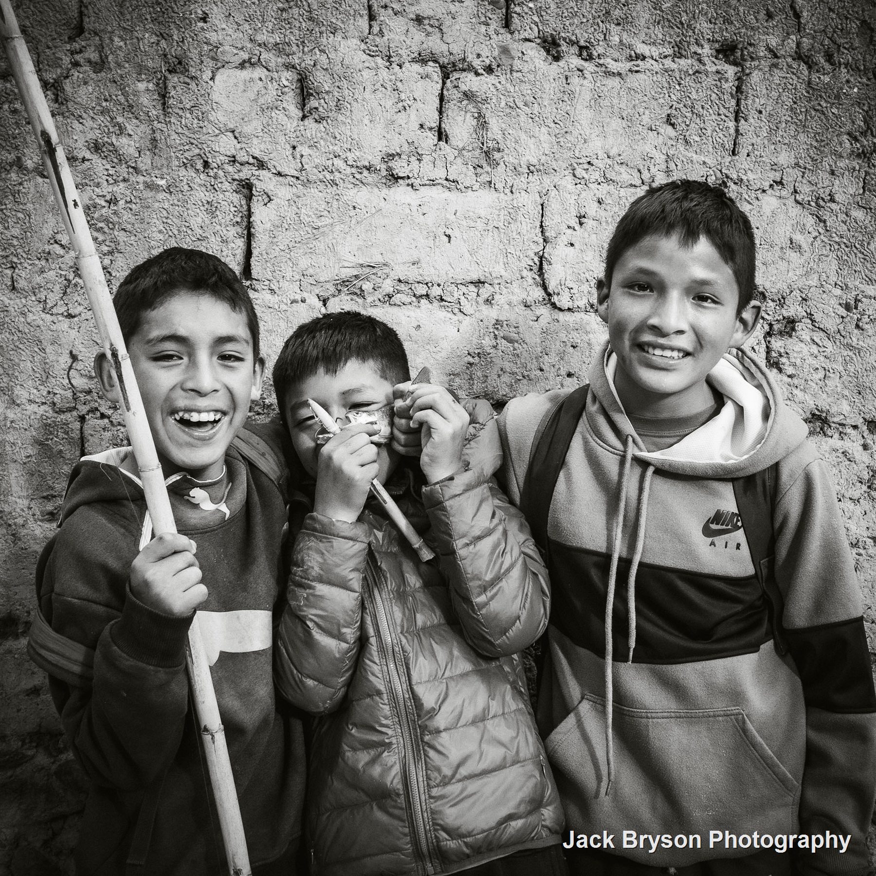 Black and white commission-style portrait of smiling children